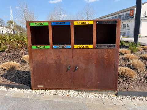 Rusty Recycling Component With Labels. Weathered Recycling Unit Highlighting Industrial Wear And Color