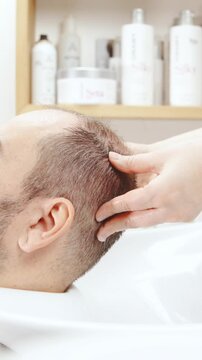 Man head massage at hairdresser salon in slow motion