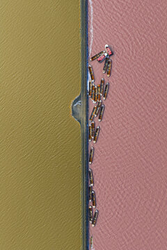 Aerial view of a colorful abstract background with gold and pink contrasting sharply, San Pedro del Pinatar, Region of Murcia, Spain.