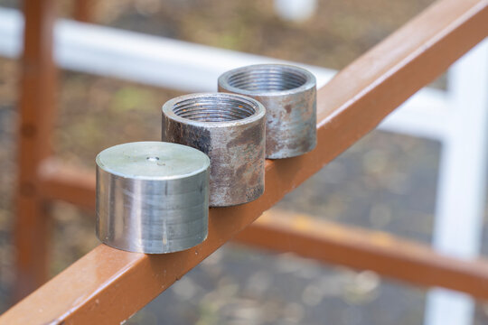 Metal threaded cylinders with rust and steel contrast