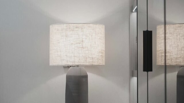 Modern minimalist table lamp with mirror reflection in an interior setting