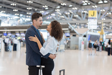 Fototapeta premium Couple hugs at airport before departure