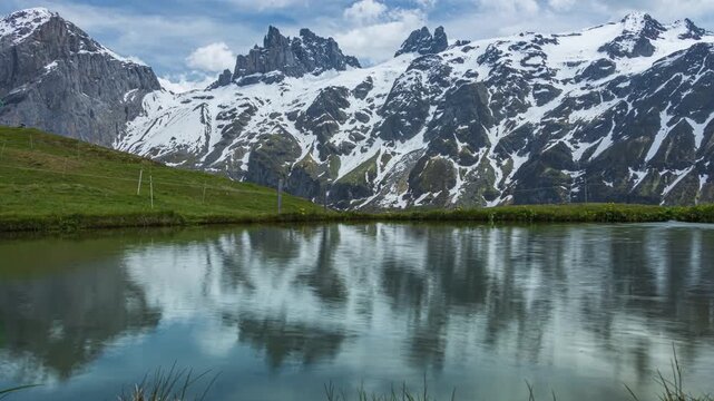Time lapse, mountain reflection on the Spiegelseeli lake. Mountain landscape near Engelberg, Switzerland.