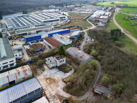 Aerial view of industrial buildings juxtapose with nature's embrace, showcasing a blend of manufacturing and greenery, Detva, Banskobystricky kraj, Slovakia.