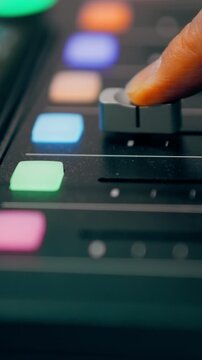 pushing fader audio mixer soundboard professional studio equipment. Music producer adjusting volume level mixing console recording studio. Close up sliding potentiometer control