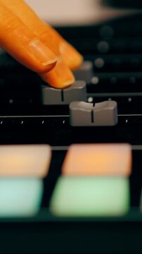 Hand turning knob audio mixer controller studio. Producer adjusting sound levels digital workstation hardware interface. Close up view electronic musician performing live set midi device