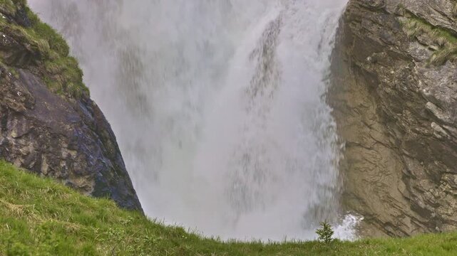 Closeup view on a mountain waterfall with water cascading down from rocky cliffs. Staeuberfall waterfall, Switzerland.
