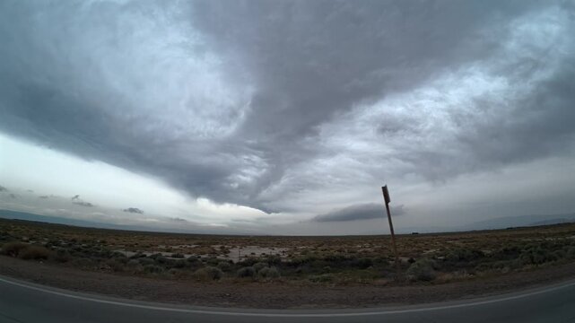 Passenger-Side Drive Through Desert Under Gloomy Cloudy Skies