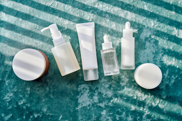 Cosmetic containers and skincare products on velvet background