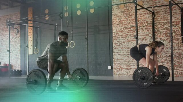Partners practicing deadlifts in gym in sync, driving legs, lifting barbells amid scanline overlay