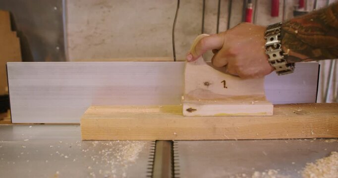 Carpentry equipment. Joiner work. Male hand processing wood on thickness planer electrical professional machine. Powerful timber industry tool.