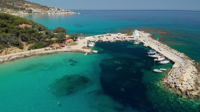 The beach and port of Gialiskari and the chapel Analipsi, Ascention in Ikaria island, Greece