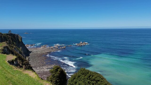 Panoramic aerial drone shot of spectacular green cliffs and turquoise ocean water on the Asturian coast Northern Spain