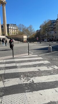 Sunlit Paris plaza with cobblestones and classical architecture