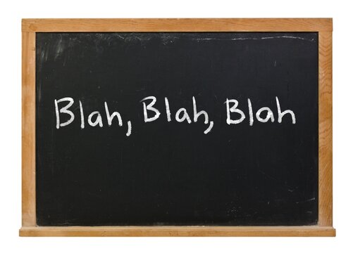 Blah, blah, blah written in white chalk on a black chalkboard in a wooden frame isolated on white