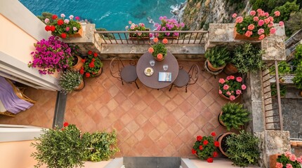 Obraz premium Aerial terrace courtyard with round table chairs and flowering pots for outdoor patio background and travel banner