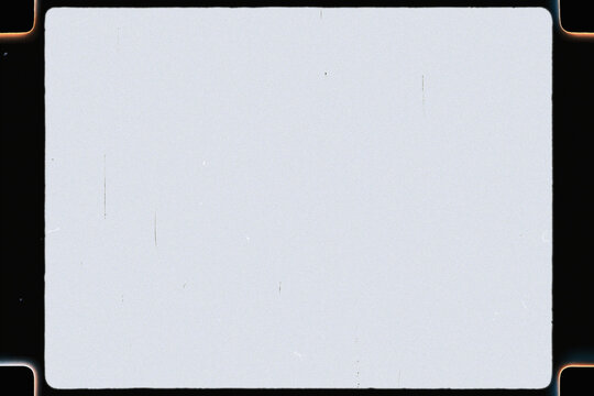 Vintage movie film frame with old light leaks, dust, grain, and blank screen overlay texture