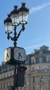 Charming historic street clock beneath vibrant daytime sky detail