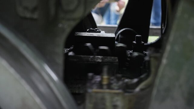 Close up of mechanical details, wheels and piston of a vintage steam engine. Historic locomotive, industrial heritage, 4K, ProRes, 50fps.