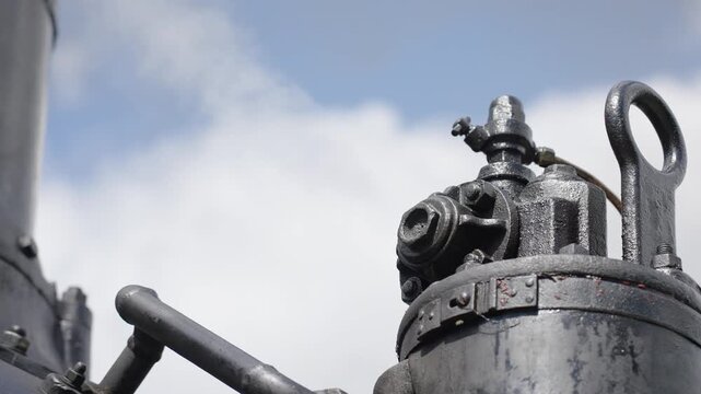 Close up of mechanical steaming details, wheels and piston of a vintage steam engine. Historic locomotive, industrial heritage, 4K, ProRes, 50fps.