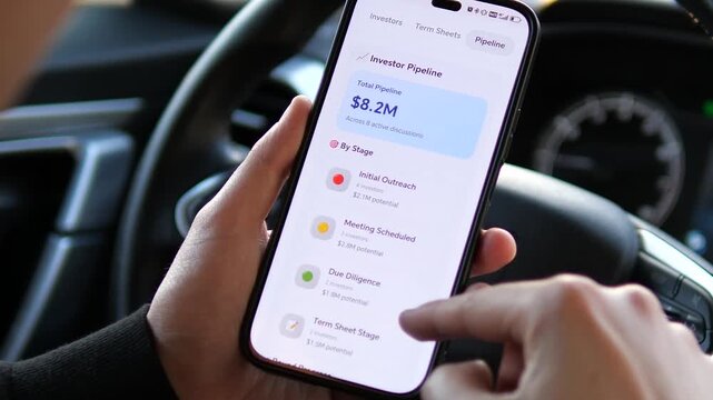 Success in motion: Tracking multi-million dollar investments via mobile app. Man reviews due diligence and term sheets on phone. High-quality footage for corporate success, mobile banking, and modern