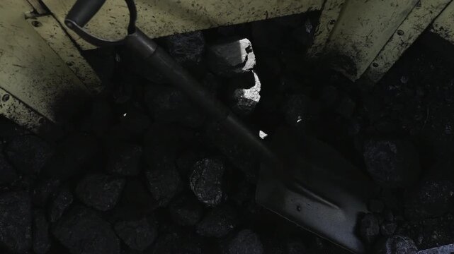 Inside view of a vintage steam locomotive coal bunker with fuel for the engine. Close up of coal pile in the historic train cabin, industrial heritage, 4K, ProRes, 50fps.
