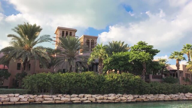 Madinat Jumeirah Dubai traditional Arabian architecture and waterways glowing at golden hour sunset UAE