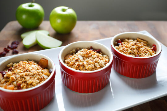 Individual apple crumble desserts in ramekins