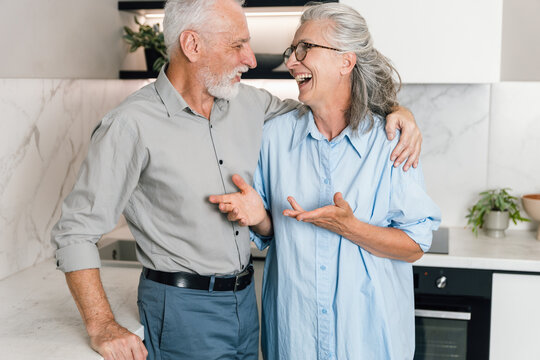 Senior couple enjoys time together at home on a weekend morning