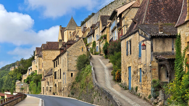 Beautiful streets in the village of Beynac-et-Cazenac, France with medieval stone houses climbing the cliffs of the Dordogne river.
