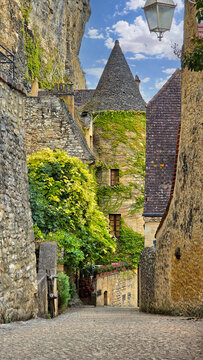 Beautiful street in the village of La Roque-Gageac, Dordogne, France with medieval vine covered turreted architecture