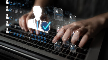 Hands typing on a laptop with digital interface showing documents and check marks symbolizing data...