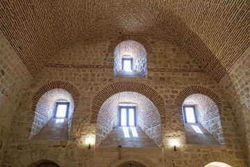 Midyat, Mardin, Turkey – August 21, 2022: Interior view of Mor Gabriel Monastery showcasing historic Syriac Orthodox architecture and stone design © aselight