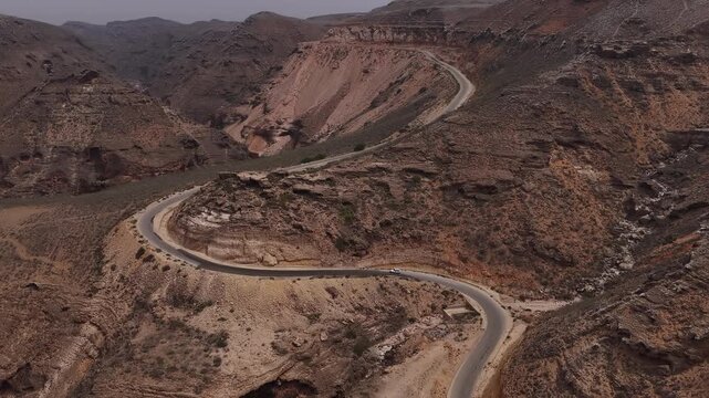 Aerial view of a car driving on a scenic mountain pass road, socotra island, yemen