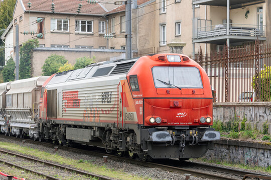 Nancy, France - April 10th 2026 : View on a white and red diesel electric locomotive Stadler EURO 4000 pulling a freight train and crossing the Nancy station.
