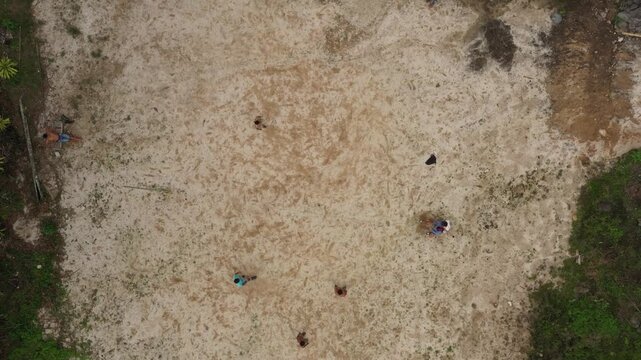 Aerial view of a few people playing volley at a sand field