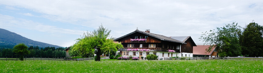 Obraz premium Old cozy typical Bavarian house in the Alps, Germany. Banner