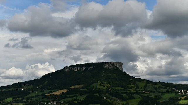 Time lapse video of the Pietra of Bismantova at sunset with a cloudy sky. Castelnuovo Monti, Reggio Emilia, Italy