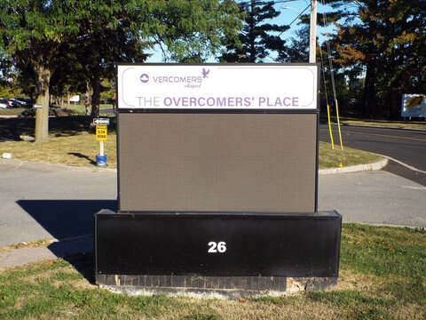 Ottawa, Ontario, Canada &ndash; July 27, 2025: A sign for "The Overcomers' Place" at 26 Auriga Drive in Ottawa features a digital display board and purple lettering.
