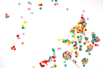 Fototapeta premium lollipop and confetti on a white background