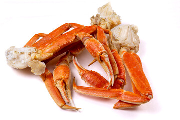 Cooked snow crab clusters showing teh claws in a pile isolated on white © SockaGPhoto