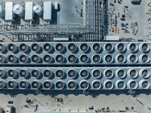 Top-down aerial of an AI data center with extensive cooling fans, piping, and infrastructure, highlighting large-scale computing, thermal management, and industrial technology systems.
