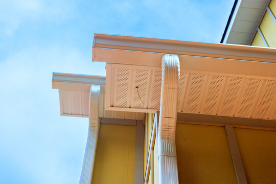 House with yellow panel Hardie siding walls dark roof stands