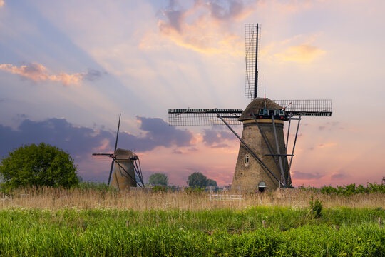 Kinderdijk windmills standing in Dutch landscape at sunset