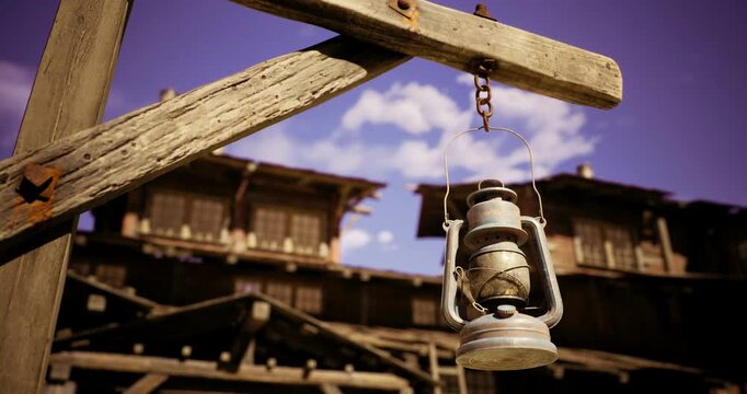 A vintage lantern dangles from a weathered wooden beam, showcasing its rustic charm against a backdrop of a historic wooden structure. The bright blue sky adds warmth to the scene.