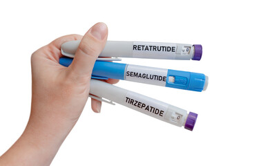 Obraz premium Hand holding GLP-1 injection pens with semaglutide tirzepatide and retatrutide isolated on light background