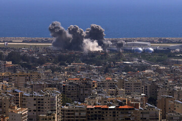Naklejka premium Baabda, Lebanon - April 11 2026: Smoke rises following an Israeli strike on the southern suburbs of Beirut as seen from Baabda illustrating ongoing conflict in the region