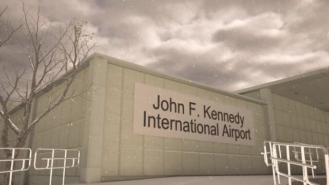 John F Kennedy International Airport exterior with airplane overhead in winter snowfall, New York, United States