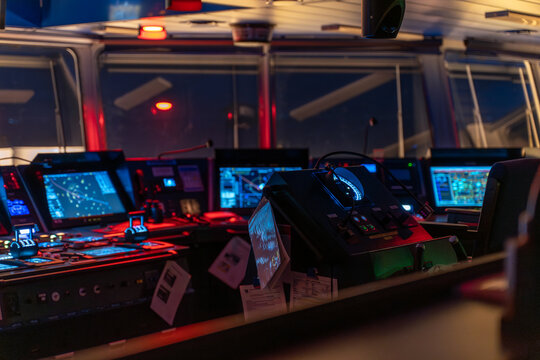 Ship wheelhouse interior with dim lighting and navigation equipment