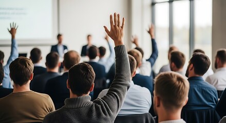 Fototapeta premium Audience Raising Hands During Presentation in Conference Room.